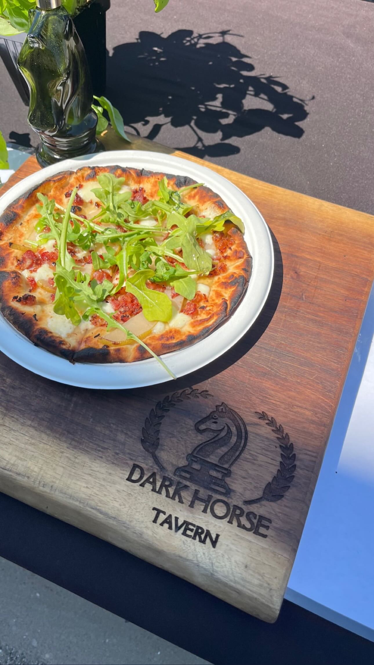 The Perfect Bite flatbread served on a branded Dark Horse Tavern board